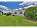 Backyard view showcasing a home with lush lawn and manicured landscaping at 336 Cruisers Dr, Polk City, FL 33868