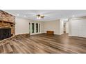 Spacious living room with brick fireplace and wood flooring at 7510 Catherine Dr, Lakeland, FL 33810