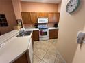 Kitchen with wood cabinets and white appliances at 8425 Crystal Cove Loop, Kissimmee, FL 34747