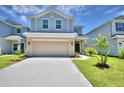 Two-story house with a neutral color scheme and a two-car garage at 1492 Leamington Ln, Winter Haven, FL 33884