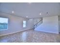 Bright living room with tile floors and a staircase at 1417 Leamington Ln, Winter Haven, FL 33884