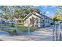 House with chain link fence and a paved driveway at 208 W Bullard Ave, Lake Wales, FL 33853