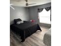 Bedroom with a queen bed, twin bed, and ceiling fan at 50989 Highway 27 # 230, Davenport, FL 33897