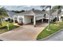 White house with covered carport and landscaped yard at 352 Meandering Way, Polk City, FL 33868