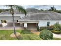 Rear view of house showing covered patio area at 352 Meandering Way, Polk City, FL 33868