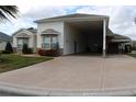 One story home with covered carport and landscaping at 352 Meandering Way, Polk City, FL 33868