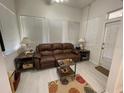 Bright sunroom with a comfortable leather sofa and large windows at 336 Motorcoach S Dr, Polk City, FL 33868