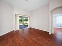 Bright Gathering room featuring hardwood floors and sliding doors to the pool at 988 Classic View Dr, Auburndale, FL 33823