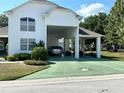 Two-car garage with covered carport at 1214 Motorcoach Dr, Polk City, FL 33868