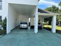 Covered carport with space for two vehicles and golf cart at 1214 Motorcoach Dr, Polk City, FL 33868