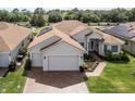 Aerial view of house with solar panels at 6265 Pinehurst Loop, Winter Haven, FL 33884