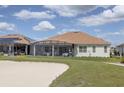 House exterior with screened patio at 6265 Pinehurst Loop, Winter Haven, FL 33884