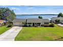 Single story home with lake view, large yard, and long driveway at 274 Paradise Island Dr, Haines City, FL 33844