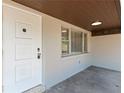 Inviting front porch with a white door and light gray walls at 724 Hillside Ave, Lake Wales, FL 33853