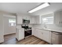 Modern kitchen with white shaker cabinets and stainless steel appliances at 318 Senate St, Auburndale, FL 33823