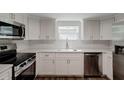 Modern kitchen with white cabinets and stainless steel appliances at 318 Senate St, Auburndale, FL 33823