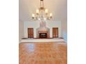 Living room with fireplace and chandelier at 4301 Se 6Th Ave, Ocala, FL 34480