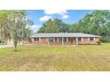 Brick ranch home with a spacious lawn and mature trees at 3479 Arrowwood Dr, Lakeland, FL 33811
