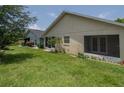 Exterior view of the house showcasing a screened-in patio and backyard at 6118 Silver Lakes W Dr, Lakeland, FL 33810