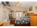 Main bedroom with floral bedding, ceiling fan, and access to backyard at 6118 Silver Lakes W Dr, Lakeland, FL 33810