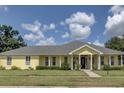 Ranch-style home with gray roof and yellow siding at 745 Square Lake E Dr, Bartow, FL 33830