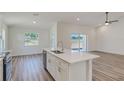 Modern kitchen with white cabinets and island at 1038 Thompson Ave, Frostproof, FL 33843