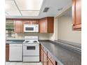 Galley kitchen with wood cabinets and appliances at 2025 Sylvester Rd # C4, Lakeland, FL 33803