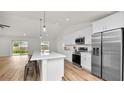 Modern kitchen with white cabinets, stainless steel appliances, and an island at 840 Voight N Ave, Fort Meade, FL 33841