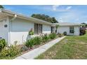 Landscaped walkway along the side of the house with lush greenery at 152 Audubon Ct, Winter Haven, FL 33884