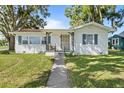 Charming white brick home with a welcoming front porch at 2408 Lake Ariana Blvd, Auburndale, FL 33823