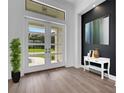 Spacious entryway with double doors and console table at 1969 Grasslands Blvd, Lakeland, FL 33803