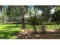 Brick home with mature trees and a well-maintained lawn at 7520 Kathleen Rd, Lakeland, FL 33810
