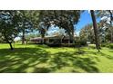 Ranch-style brick home with a covered porch and large yard at 7520 Kathleen Rd, Lakeland, FL 33810