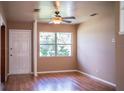 Bright living room featuring hardwood floors and a ceiling fan at 526 3Rd Ne St, Fort Meade, FL 33841