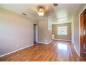 Spacious living room with hardwood floors and a view of the kitchen at 526 3Rd Ne St, Fort Meade, FL 33841