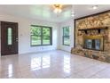 Bright living room featuring a stone fireplace and tile floors at 2508 Providence Rd, Lakeland, FL 33805