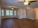 Spacious living room with wood-look floors and ceiling fans at 727 Martinique Cir, Lakeland, FL 33803