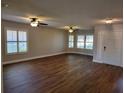 Spacious living room with wood-look floors and ceiling fans at 727 Martinique Cir, Lakeland, FL 33803