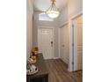 Bright entryway with wood-look floors and coat closet at 4722 Harts Brook Ln, Mulberry, FL 33860