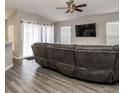 Living room with gray sectional sofa and large TV at 4722 Harts Brook Ln, Mulberry, FL 33860