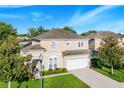 Two-story house with a two-car garage and landscaped yard at 141 Minniehaha Cir, Haines City, FL 33844