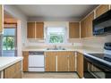 Bright kitchen features wood cabinets, built-in microwave, and dishwasher at 832 S Hill Ave # 10, Deland, FL 32724