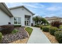 Front entrance with walkway and manicured landscaping at 2636 Huntington Hills Dr, Lakeland, FL 33810