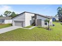 Modern one-story house with attached garage and landscaped lawn at 266 Hyacinth Ct, Kissimmee, FL 34759