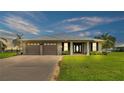 Two-car garage and a tranquil waterfront view at 7884 N Lake Buffum Shores Rd, Fort Meade, FL 33841