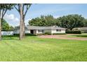 Ranch house with brick driveway and mature trees at 659 Howard Ave, Lakeland, FL 33815