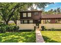 Two-story townhome with a charming front yard and walkway at 11 Loma Verde # 11, Lakeland, FL 33813