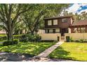 Two-story townhome nestled amongst lush trees at 11 Loma Verde # 11, Lakeland, FL 33813
