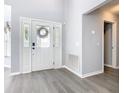 Bright entryway with white door, glass accents, and gray walls at 665 Lake Clark Pl, Lakeland, FL 33813