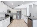 Modern kitchen with stainless steel appliances and granite countertops at 665 Lake Clark Pl, Lakeland, FL 33813